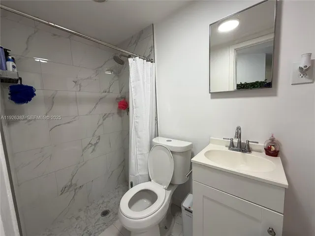 a bathroom with a toilet sink and shower