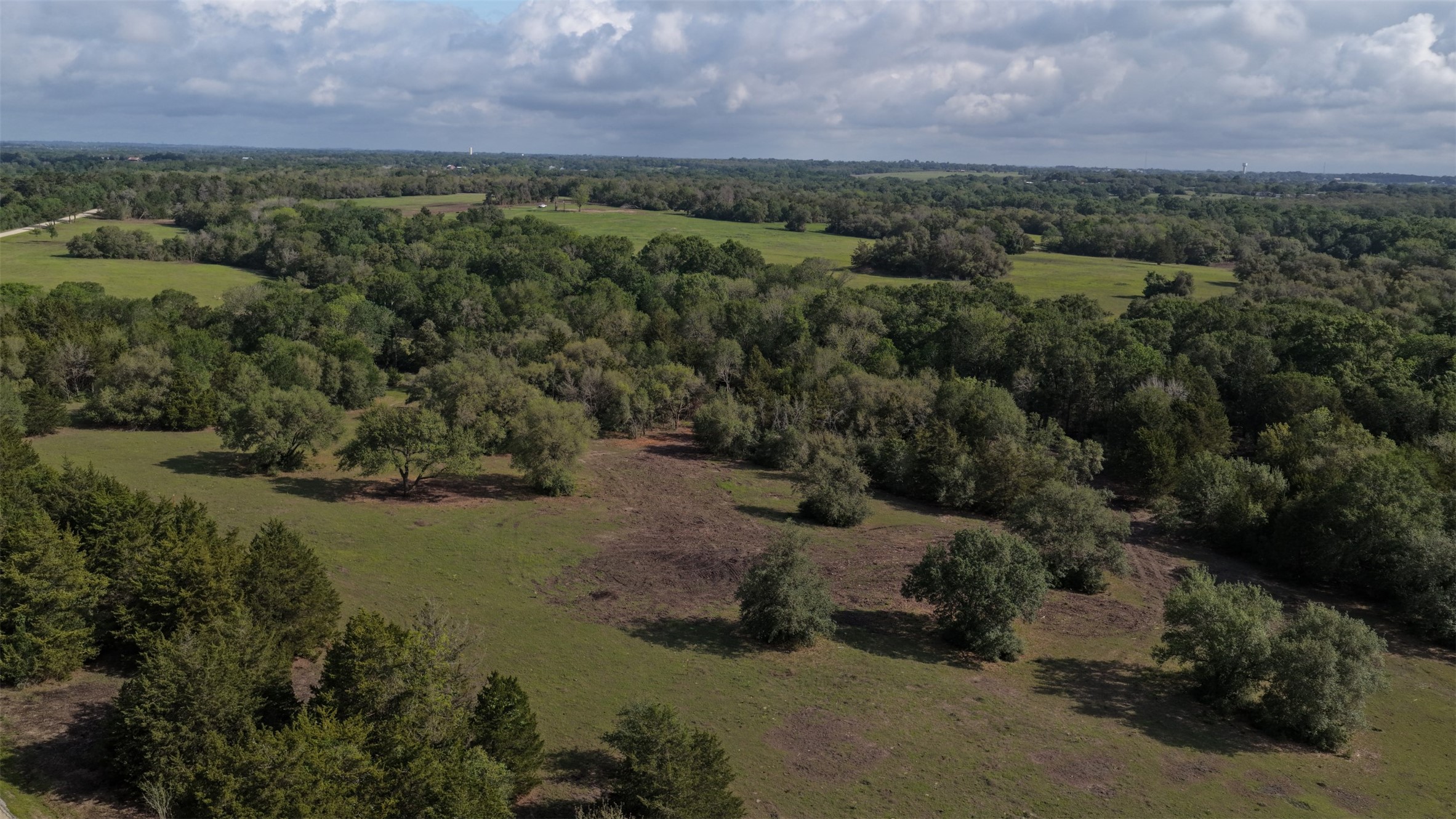 an aerial view of a houses with a yard