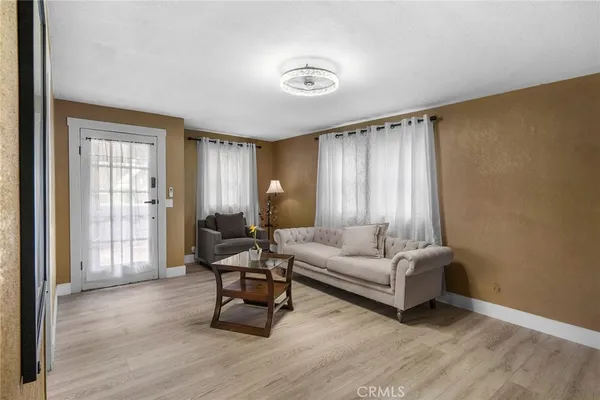 a living room with furniture and a large window