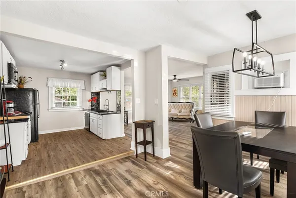 a view of kitchen with dining area refrigerator and wooden floor