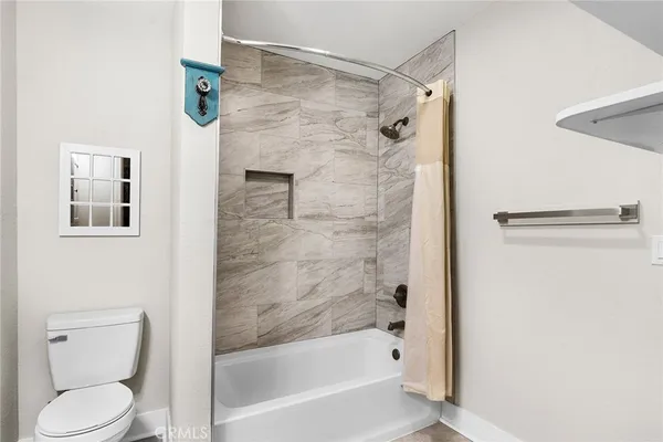 a bathroom with a shower and a toilet
