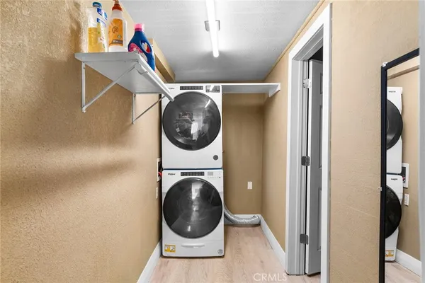 a view of a hallway with washer and dryer