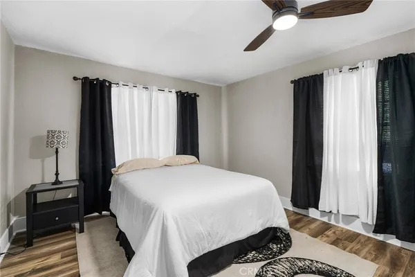 a bedroom with a bed and a flat tv screen