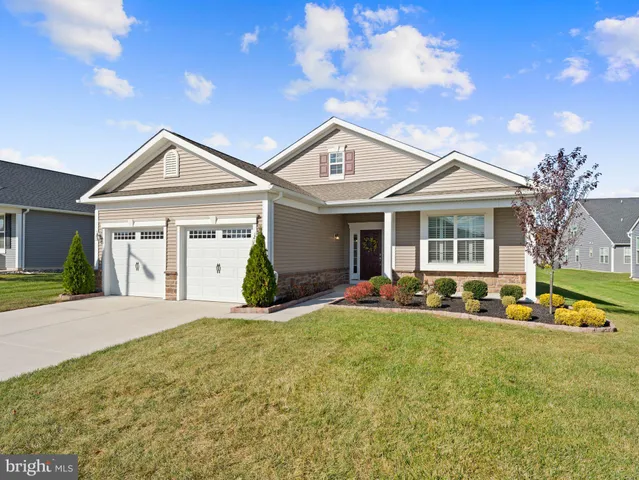 a front view of a house with a yard and porch