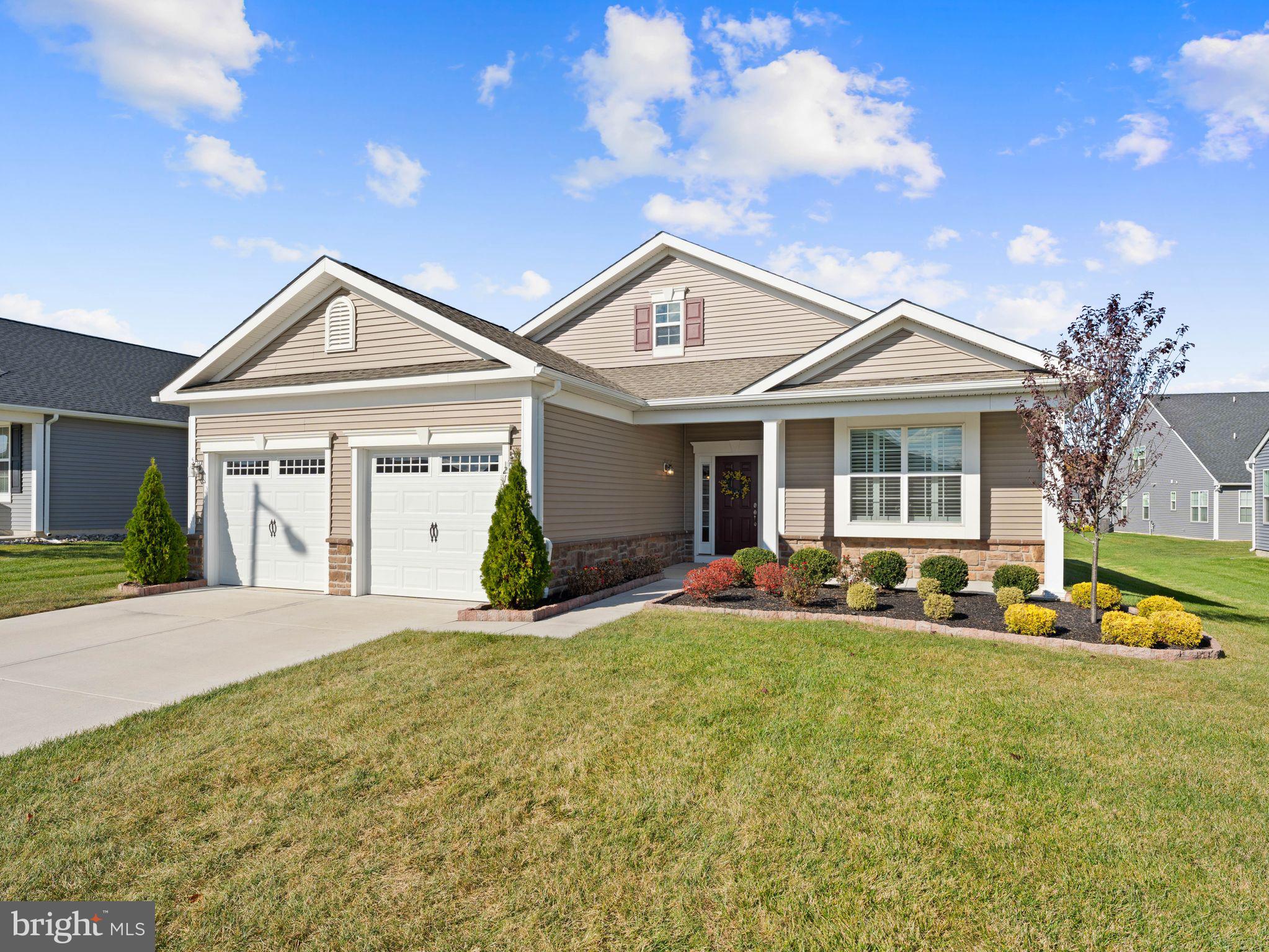a front view of a house with a yard and porch