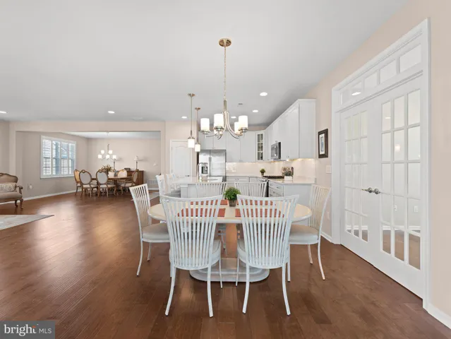 a view of a dining room with furniture wooden floor and chandelier