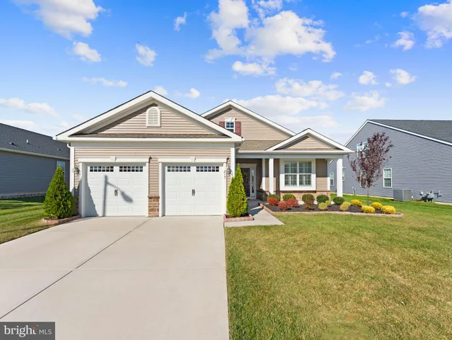 a front view of a house with swimming pool and porch with furniture