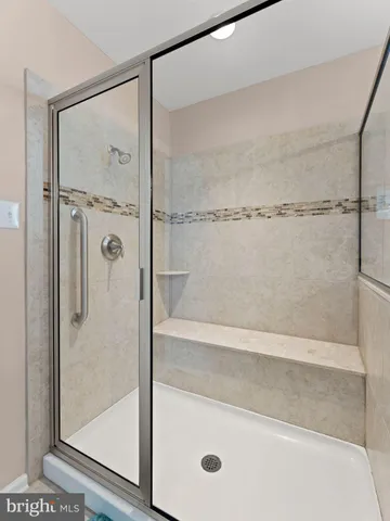 a bathroom with a glass shower door