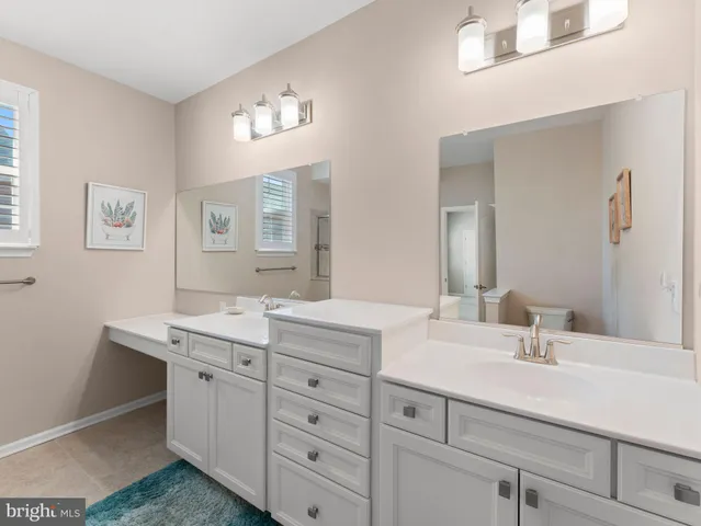a bathroom with a sink a light fixture a vanity and a mirror