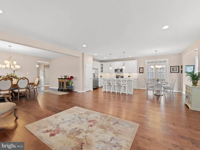 a living room with lots of furniture and wooden floor