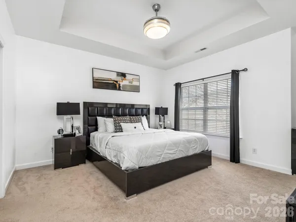 a bedroom with a large bed and a window