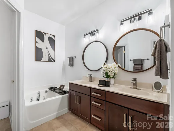 a bathroom with a double vanity sink and a mirror