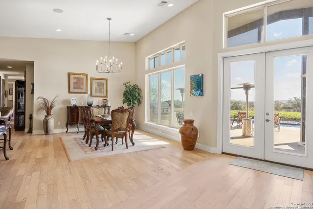 a dining room with furniture and a chandelier