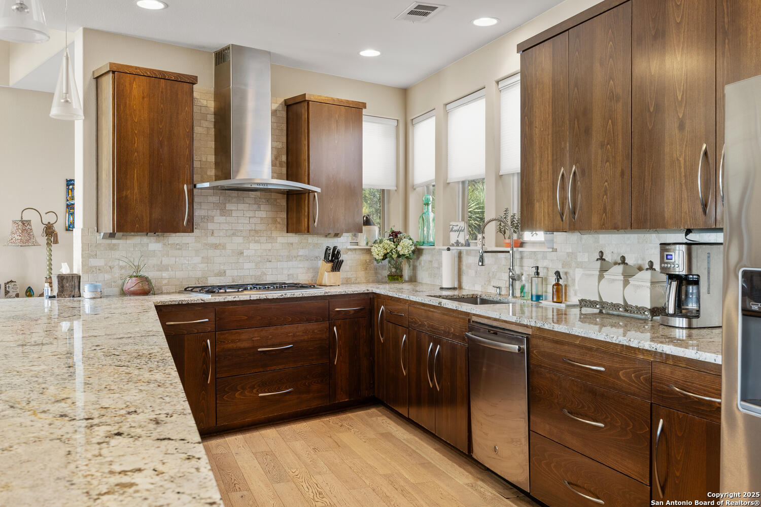 1758 Lincoln Smith Road Round Mountain, TX 78663 - Photo 17 of 50 a kitchen with stainless steel appliances granite countertop wooden cabinets a sink and dishwasher