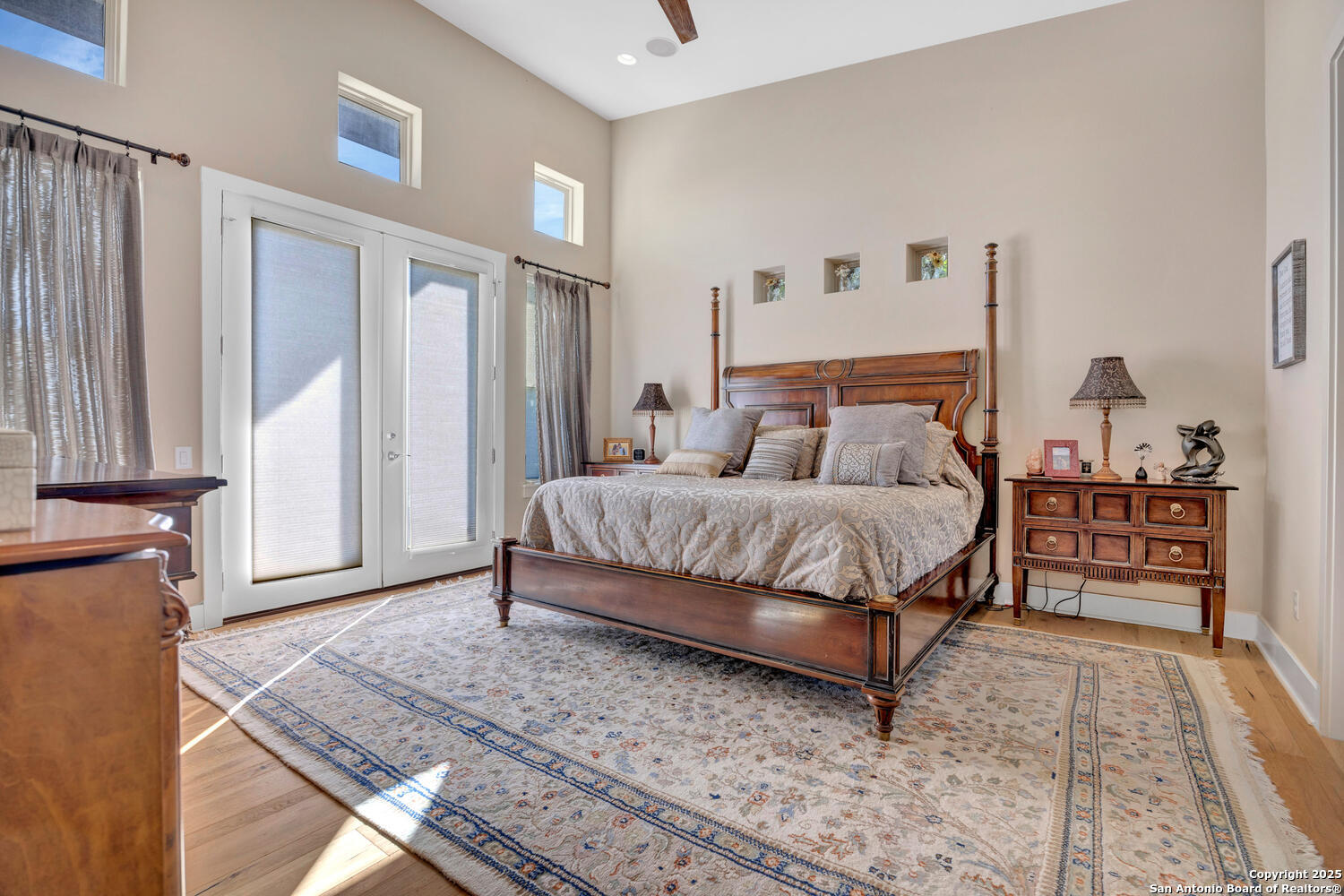1758 Lincoln Smith Road Round Mountain, TX 78663 - Photo 20 of 50 a bedroom with a bed and wooden floor