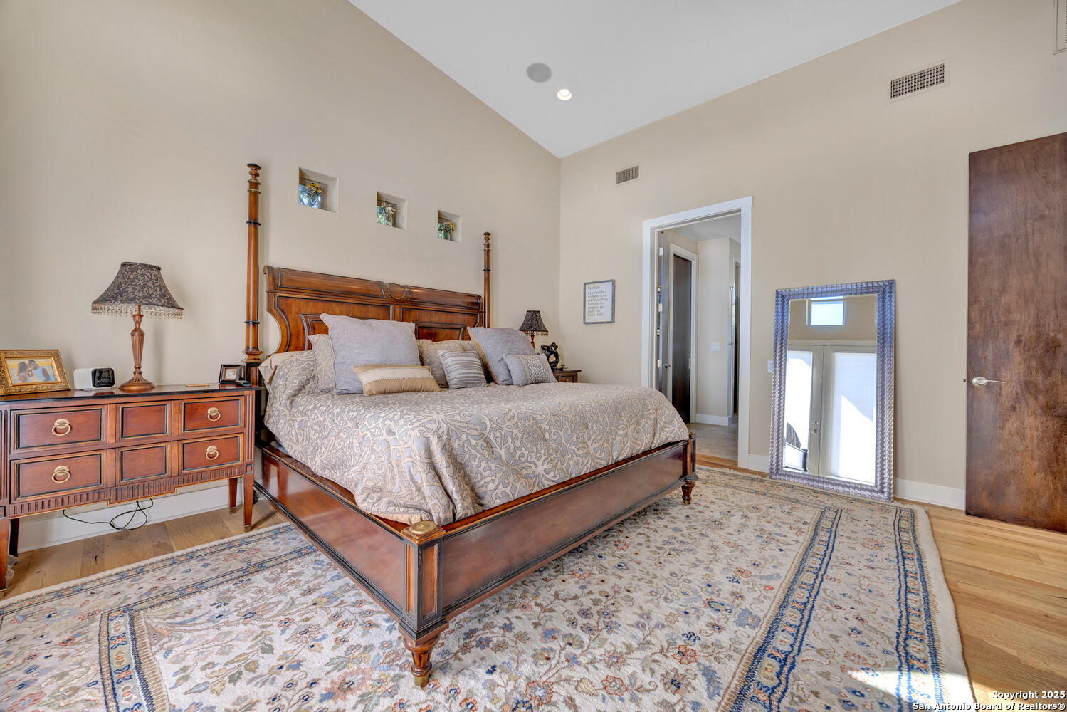 1758 Lincoln Smith Road Round Mountain, TX 78663 - Photo 22 of 50 a bedroom with a bed and wooden floor