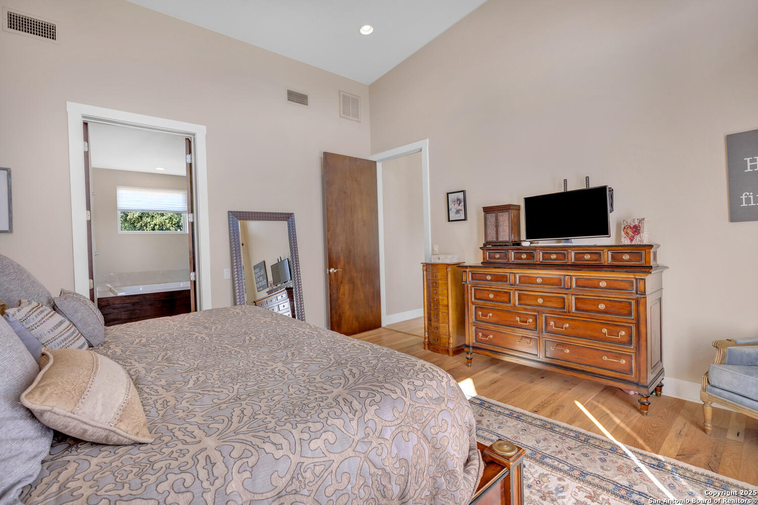 1758 Lincoln Smith Road Round Mountain, TX 78663 - Photo 23 of 50 a bedroom with a bed and a flat screen television