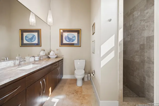 a bathroom with a toilet a sink and mirror