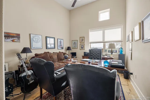 a living room with furniture a large window and a table