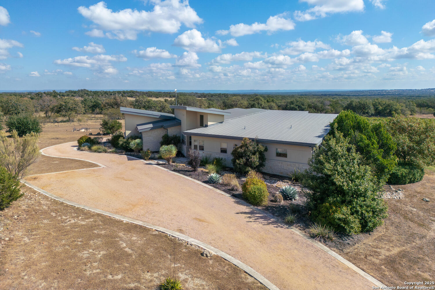 1758 Lincoln Smith Road Round Mountain, TX 78663 - Photo 4 of 50 an aerial view of a house with a garden