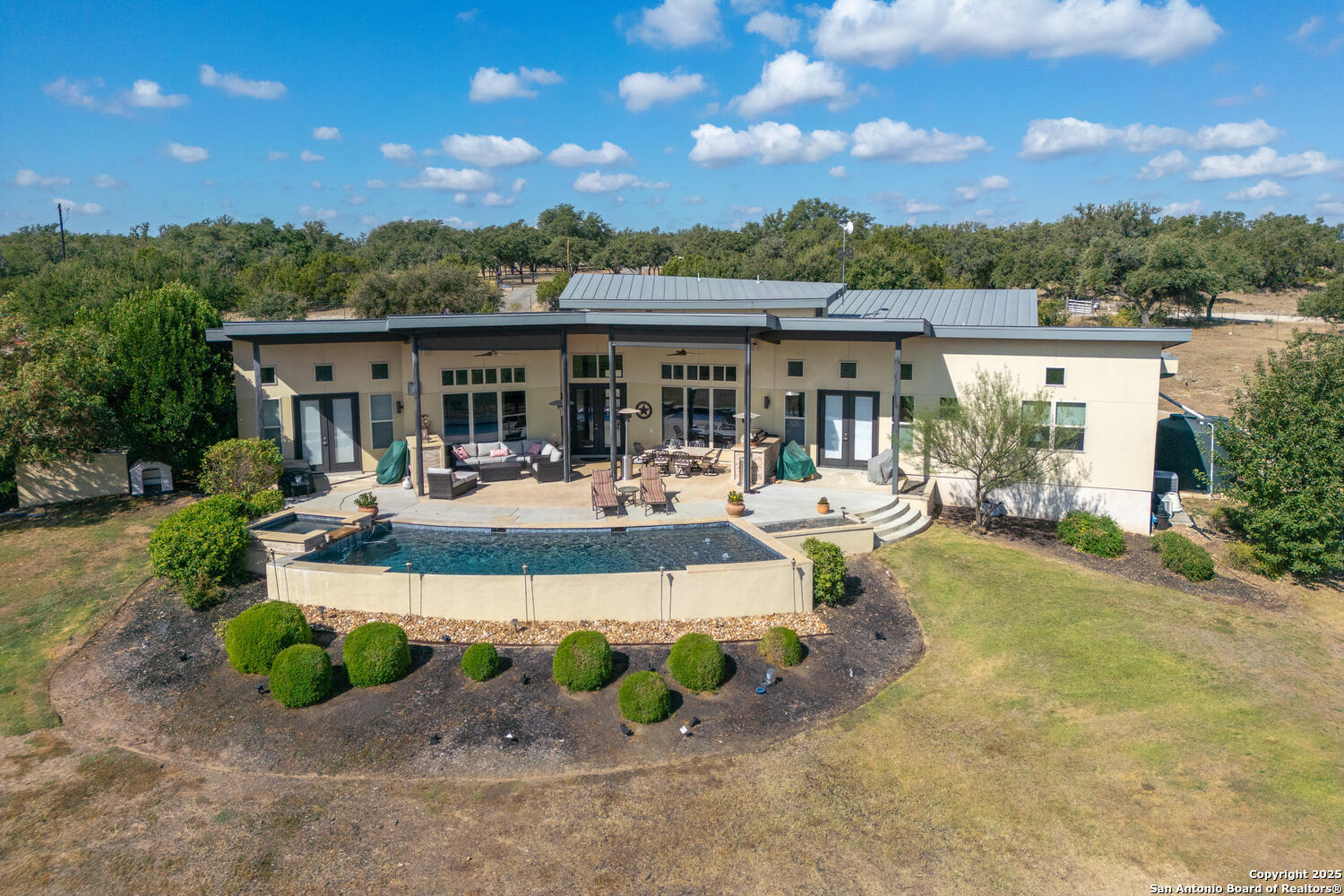 1758 Lincoln Smith Road Round Mountain, TX 78663 - Photo 43 of 50 a view of a patio with couches and table and chairs