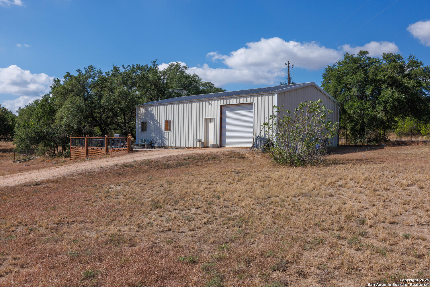 1758 Lincoln Smith Road Round Mountain, TX 78663 - Photo 47 of 50 a view of a house with a yard and large tree