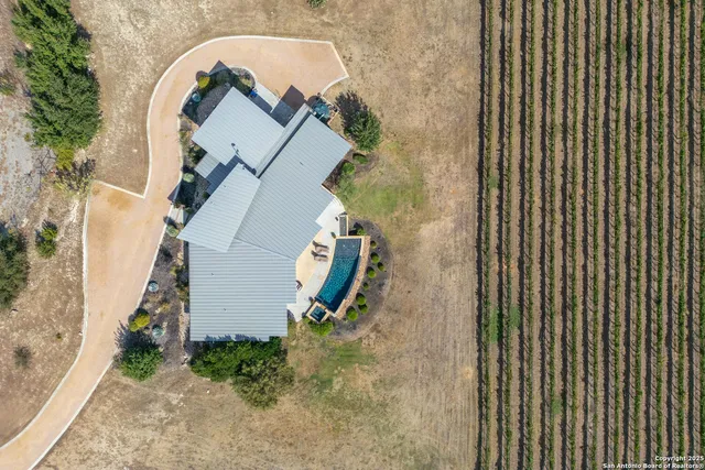 an aerial view of a house with a backyard space