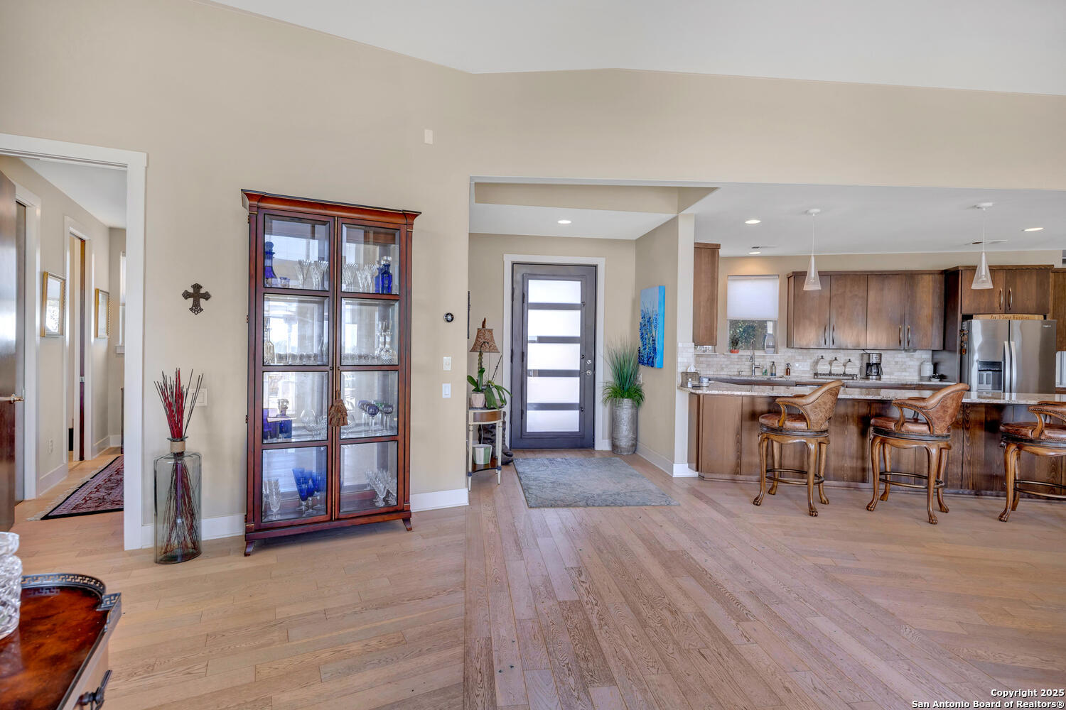 1758 Lincoln Smith Road Round Mountain, TX 78663 - Photo 5 of 50 a living room with stainless steel appliances kitchen island granite countertop furniture and a wooden floor