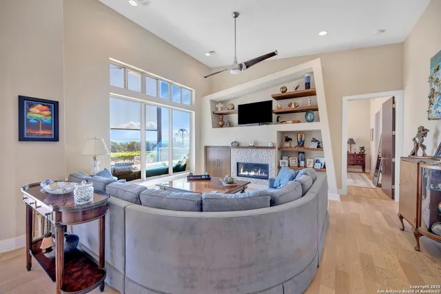 a living room with furniture a fireplace and a flat screen tv
