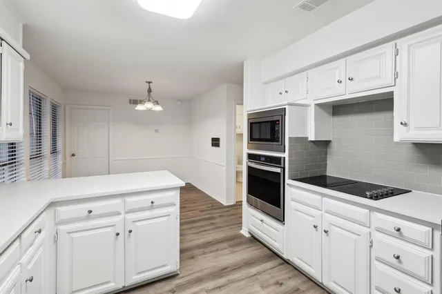 a kitchen with stainless steel appliances white cabinets and a sink