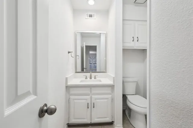 a bathroom with a sink toilet and mirror