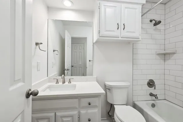 a bathroom with a sink a toilet and bathtub