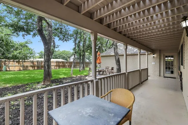 a view of a porch with a table chairs and a backyard