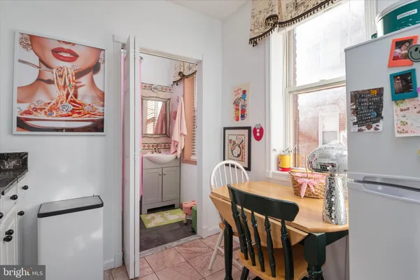 a dining room with furniture and window