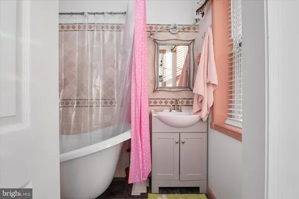 a bathroom with a bathtub and shower