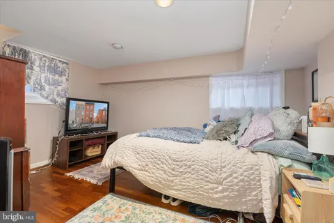 a bedroom with a bed and flat screen tv
