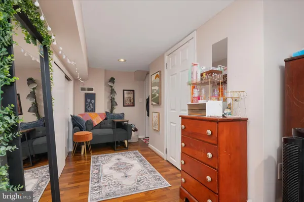 a living room with furniture and a dresser