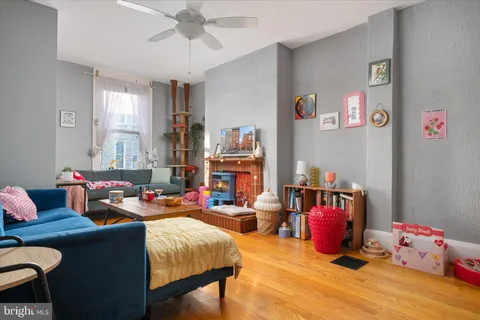 a living room with furniture toys and a window