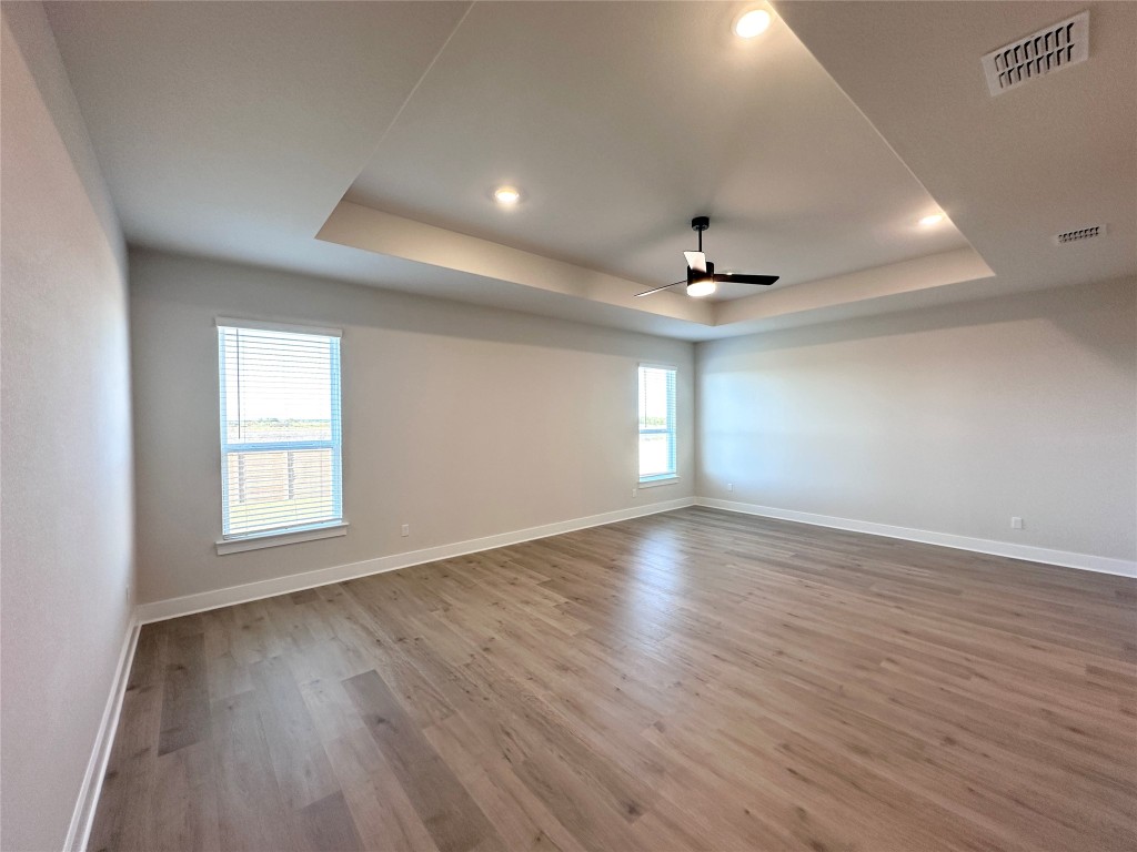 232 East Luna Blue Lane Jarrell, TX 76537 - Photo 5 of 6 a view of an empty room with wooden floor and a window