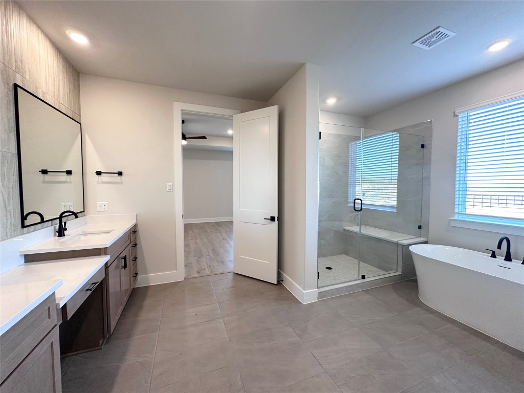 232 East Luna Blue Lane Jarrell, TX 76537 - Photo 6 of 6 a spacious bathroom with a tub sink shower and mirror