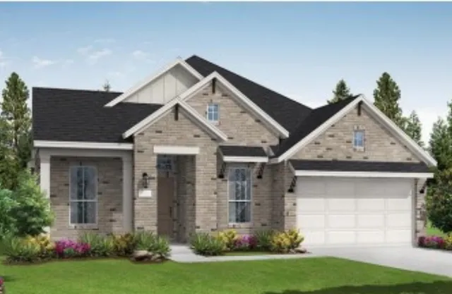 a view of a house with brick walls and a yard with plants