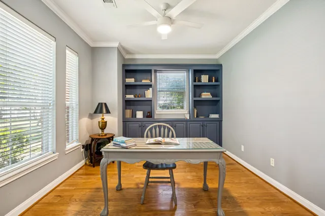 a living room with furniture a ceiling fan and a window