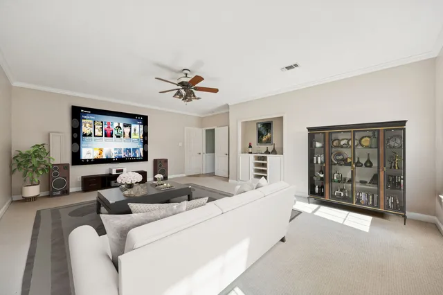 a living room with furniture and a floor to ceiling window