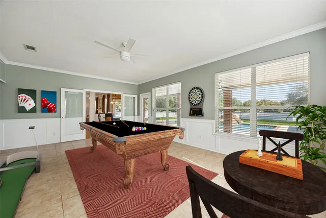 a spacious bedroom with a bed a fireplace and a large mirror