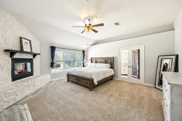a spacious bathroom with a granite countertop tub a double vanity sink a large mirror and a bathtub