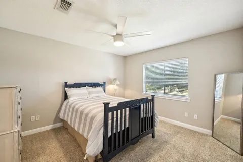 a bedroom with a bed and a couch