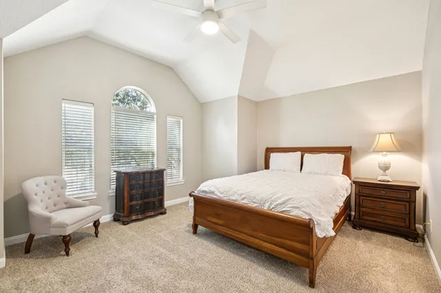 a bedroom with a large bed and a large window