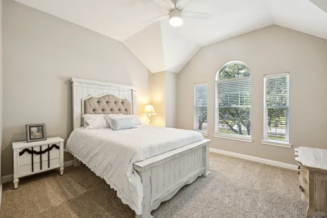 a view of a house with a big yard and large trees