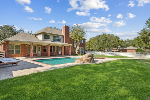 a view of a swimming pool with a patio
