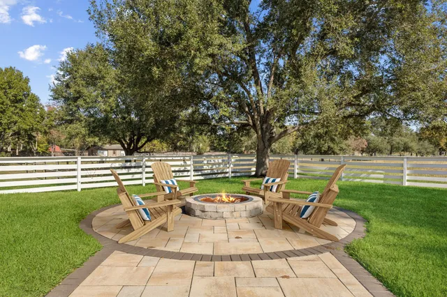 a dining room with furniture and a floor to ceiling window